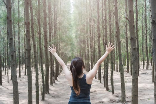 Beautiful young woman lifestyle enjoying fresh air happy relaxing in green forest park