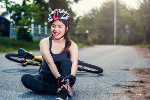 Beautiful young female woman pain injured accident sitting after bicycle falling with copy space