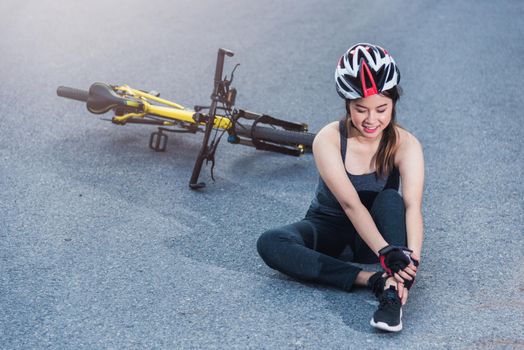 Beautiful young female woman pain injured accident sitting after bicycle falling with copy space