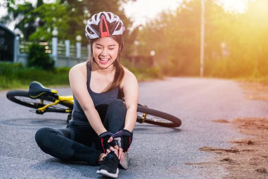 Beautiful young female woman pain injured accident sitting after bicycle falling with copy space