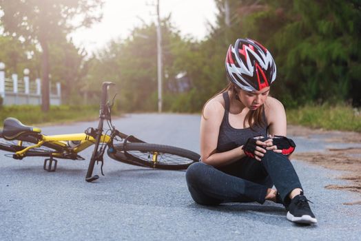 Beautiful young female woman pain injured accident sitting after bicycle falling with copy space