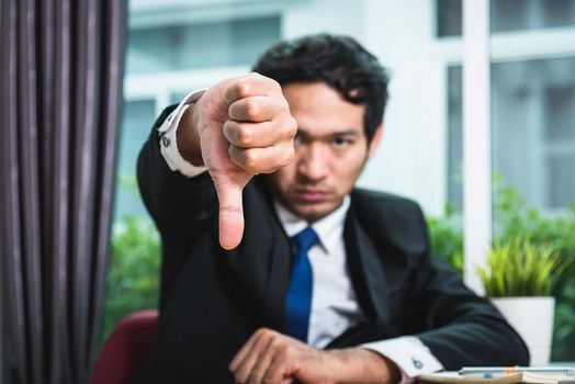 Business man sad showing thumbs down, focus hand