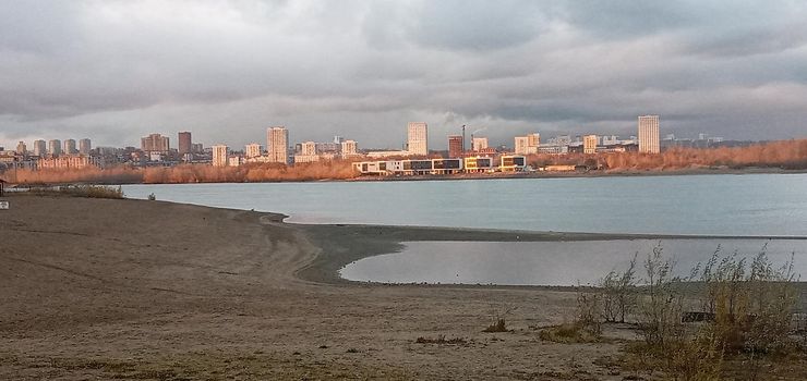 Novosibirsk, Siberia, Russia-08.15.2020: Panorama of Novosibirsk on the Ob river. The capital of Siberia on the great Siberian river, bridges, lush vegetation on river Islands, city buildings