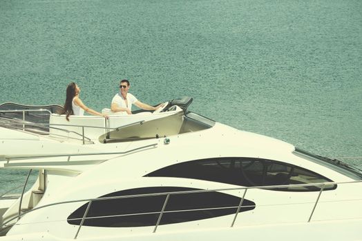 Romantic young couple spending time together and relaxing on yacht