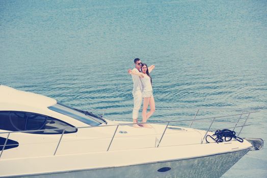 Romantic young couple spending time together and relaxing on yacht