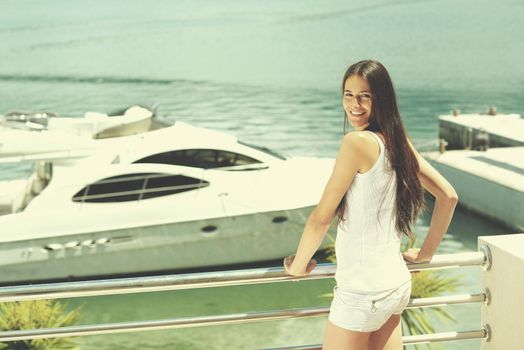 woman lies on a luxury yacht in the sea and looking to the horizon