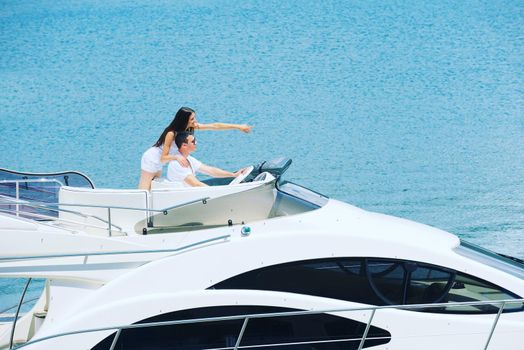 Romantic young couple spending time together and relaxing on yacht