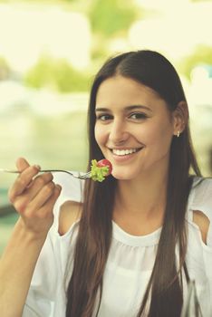 young woman have fresh healthy salad meal lunch at restaurant