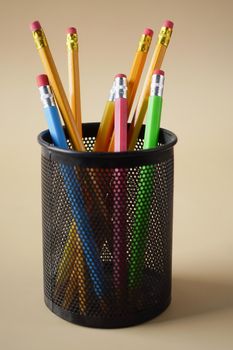 colorful pencils in a box on table .