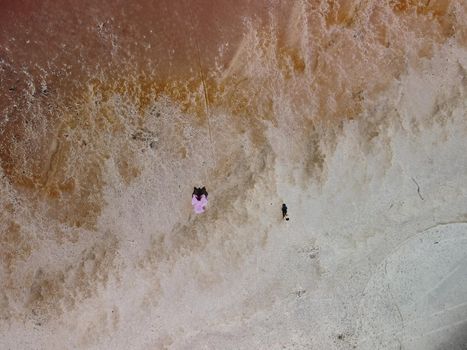 Aerial drone footage of a pink salt lake on a beautiful summer evening. Aerial view of a dried pink salt lake on a beautiful summer evening. Aerial view of a drying out salt lake.