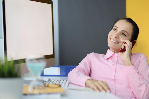 Portrait of happy office worker having break and talk on mobile phone during lunch. Lazy clerk at work, kill time chatting with friend. Job, pause concept