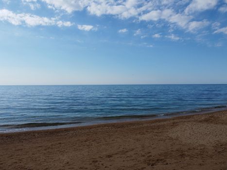 Timelapse. Beautiful remote beach with crystal clear water, aerial view. People sunbathe and swim on the pebble beach. Untouched nature, clean water. Rocky shore and hidden beach