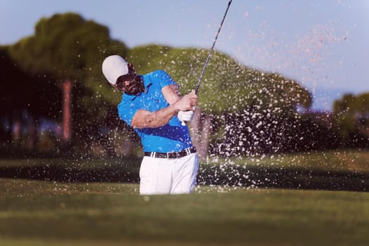 pro golf player shot ball from sand bunker at course