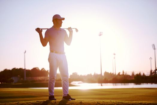 handsome middle eastern golfer portrait at golf course at beautiful sunset