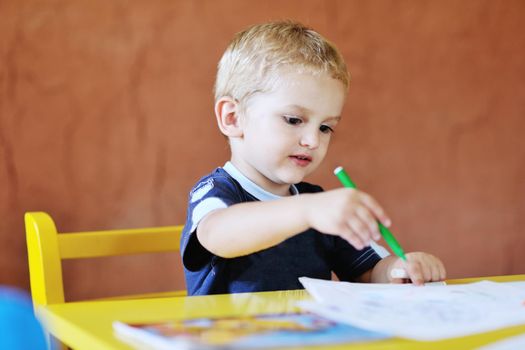 happy little child play game and have fun, education lessons in colorful kinder garden playground indoors