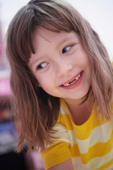 cute little girl at home painting with hands funny no tooth smile