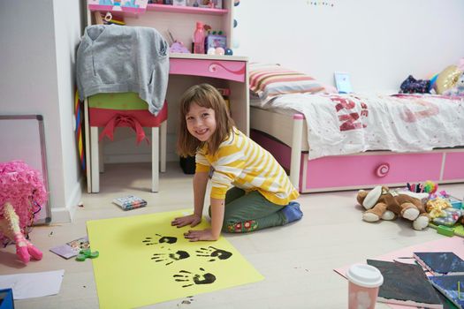 cute little girl at home painting with hands funny no tooth smile