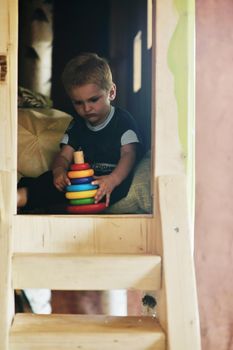 happy little child play game and have fun, education lessons in colorful kinder garden playground indoors