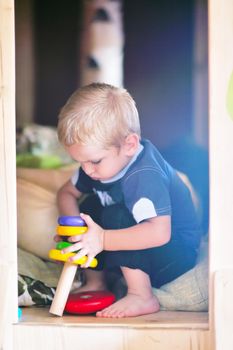 happy little child play game and have fun, education lessons in colorful kinder garden playground indoors