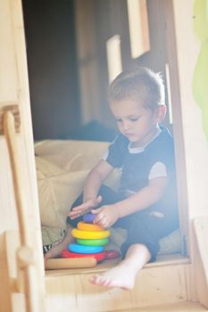 happy little child play game and have fun, education lessons in colorful kinder garden playground indoors