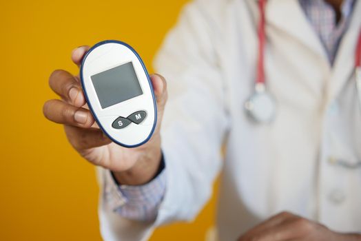 man's hand putting glucose meter in a small bag .