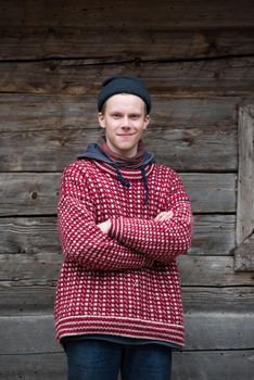 portrait of young hipster,  man with nose piercing  in front of old vintage wooden house