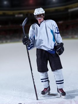 young ice hockey player portrait on training in black background