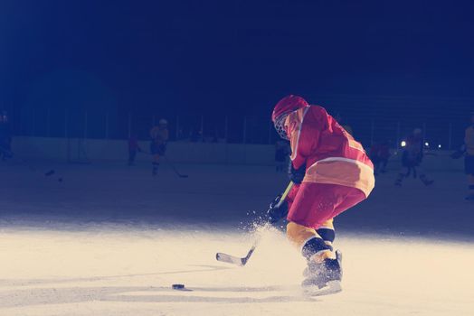 teen girl children ice hockey player in action kicking puck with stick