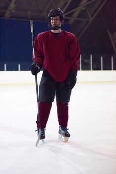 young ice hockey player portrait on training in black background
