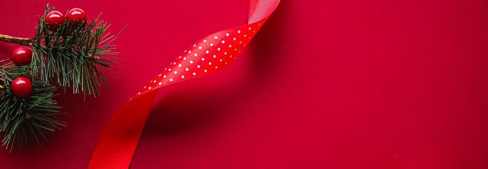 Christmas flatlay and holiday design concept. Decoration, ornament and xmas gift wrapping on red paper background as flat lay top view.