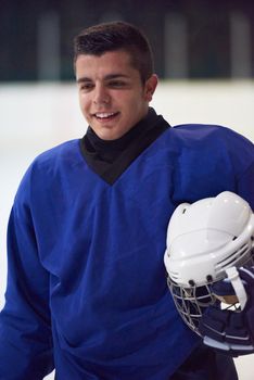 young ice hockey player portrait on training in black background