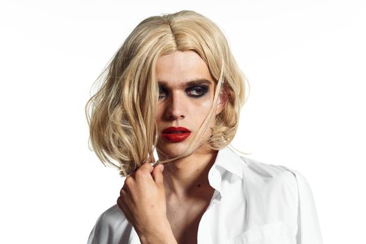 man in women's dress wig makeup posing bisexual. High quality photo