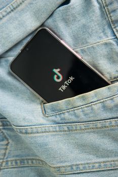 Tver, Russia-may 7, 2020, the tik tok logo on a smartphone screen sticks out of the pocket of a denim jacket. Tick-Tok icon. logo of the current app. Tiktok social network. Close up.