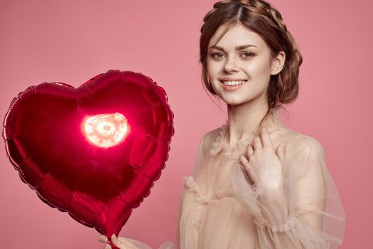 cheerful woman in a dress balloon Valentine's Day model studio. High quality photo