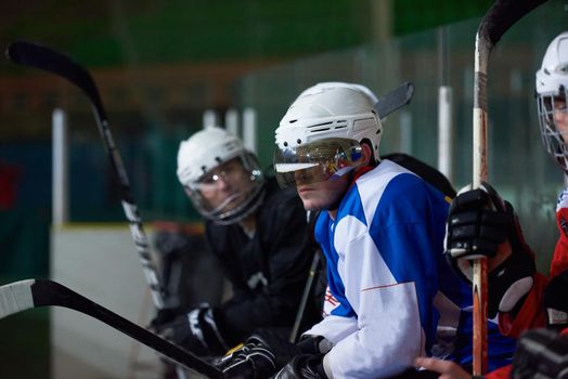 ice hockey players,  group of people,  team friends waiting and relaxing on bench to start  game