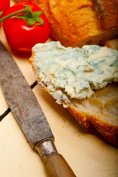 fresh blue cheese spread ove french baguette with cherry tomatoes on side