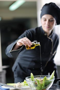 beautiful young chef woman prepare and decorating tasty food in kitchen