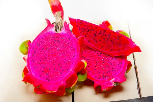 fresh thai purple dragon fruit over white rustic table