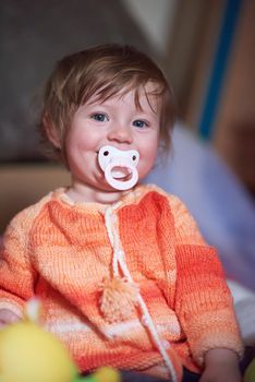 cute little child baby girl  playing with toys at home