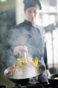 beautiful young chef woman prepare and decorating tasty food in kitchen