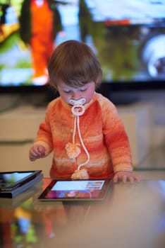 baby playing with tablet computer  at home