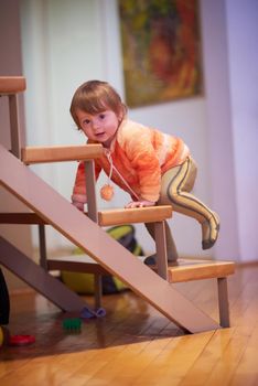 cute little child baby girl  playing with toys at home