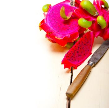 fresh thai purple dragon fruit over white rustic table