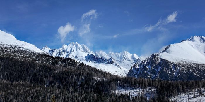 Vysoke Tatry panorama on a sunny spring day. Peaks "Kopky, Tazky stit, Vysoka, Draci stit and Ganek" visible covered under snow. Strbske pleso, Slovakia.