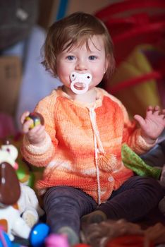 cute little child baby girl  playing with toys at home