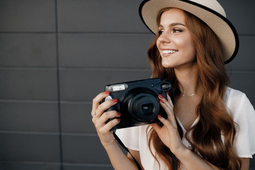 happy woman with camera outdoor. High quality photo