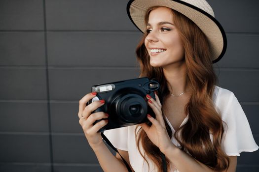 happy woman with camera outdoor. High quality photo