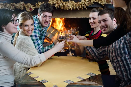 happy Young romantic couple sitting on sofa in front of fireplace at winter season in home