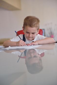 young mom woman doing home work with elementary school grade boy at home in kitchen