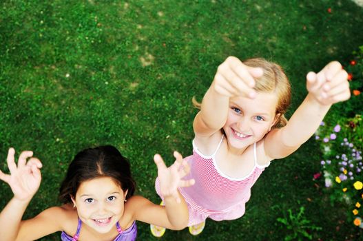 two happy young girls children  have fun outdoor in nature